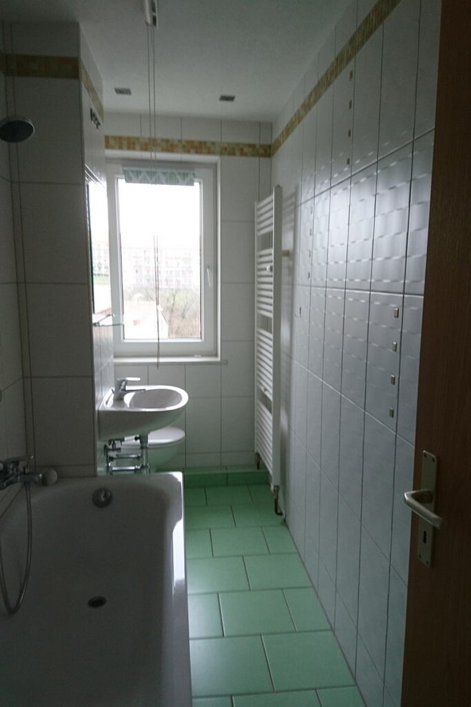 Mehrfamilienhaus in der Meischnerstraße 79 in Penig Badezimmer mit Badewanne, Waschbecken, Toilette, Fenster und Handtuchheizung